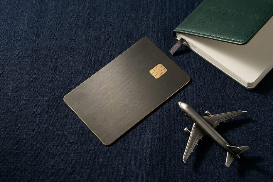 Best travel credit cards of 2026 — premium metal card with passport and airplane representing free flights and hotel nights earned with rewards points